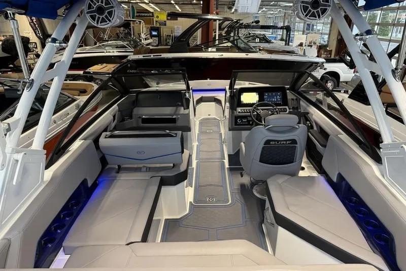 Slide: The Image of 2026 Cobalt R4 Surf boat interior with modern dashboard and seating in showroom. - 3