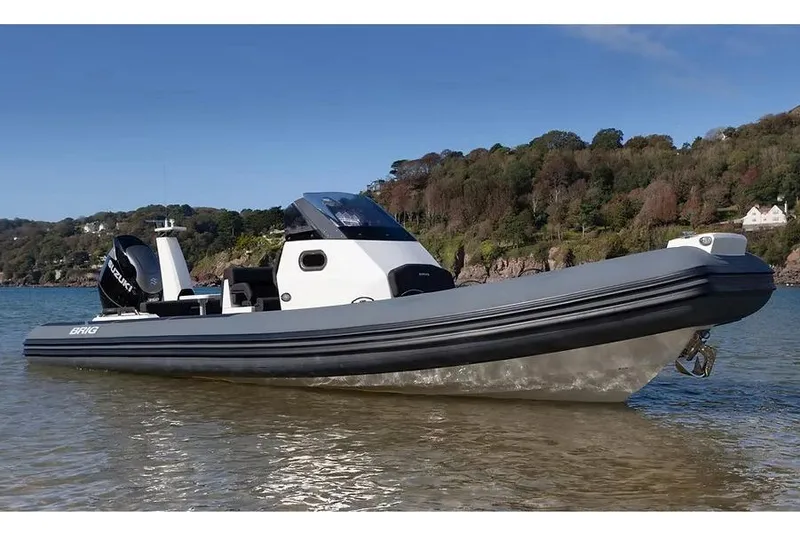 Slide: The Image of Manufacturer Provided Image: 2026 Brig Eagle 8 boat on calm water with scenic forested background. - 2