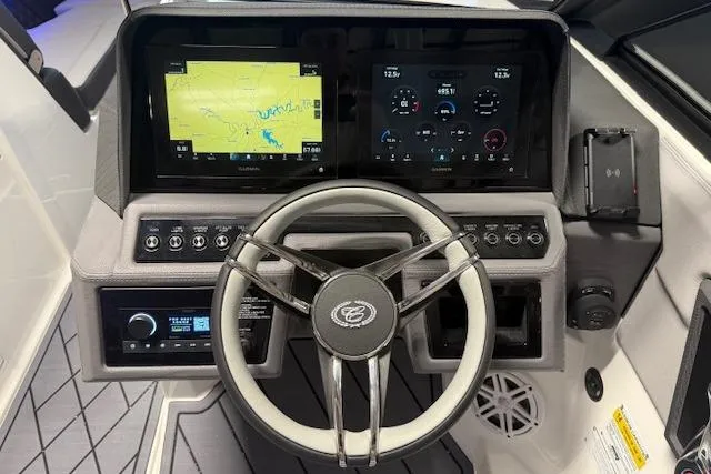 Slide: The Image of 2026 Cobalt R6 boat dashboard with steering wheel, digital displays, and navigation system. - 12
