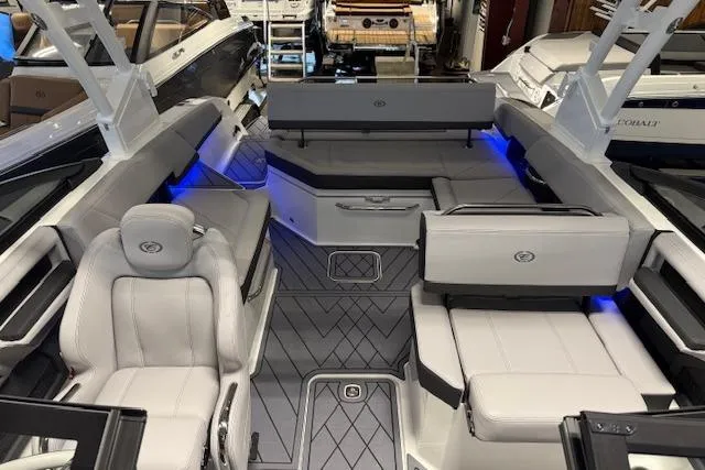 Slide: The Image of 2026 Cobalt R6 boat interior with modern seating and ambient blue lighting. - 6