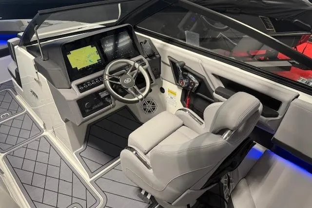 Slide: The Image of 2026 Cobalt R6 boat cockpit with modern steering, navigation screens, and luxurious seating. - 11