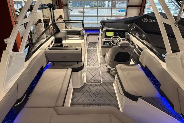 Slide: The Image of 2026 Cobalt R6 boat interior with modern seating, illuminated accents, and advanced dashboard controls. - 13