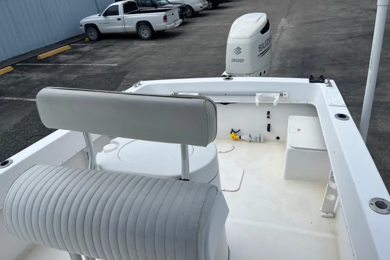 Slide: The Image of Duskey 256 boat interior with Suzuki 300 engine, parked near vehicles, 2007 model. - 18