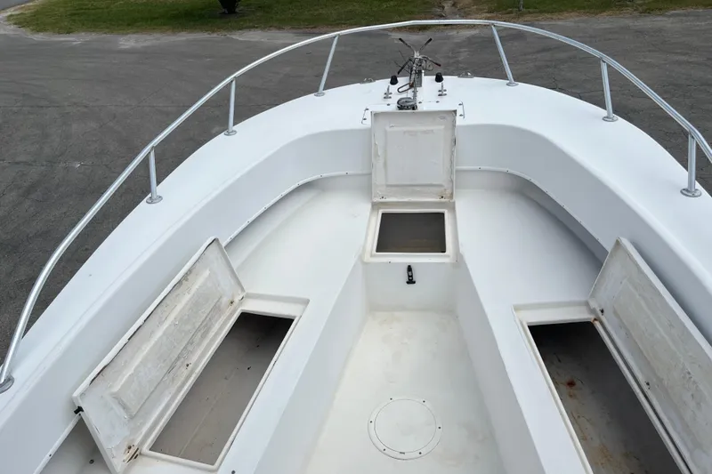 Slide: The Image of Duskey 256 boat interior, 2007 model, featuring open storage compartments and clean white deck. - 11