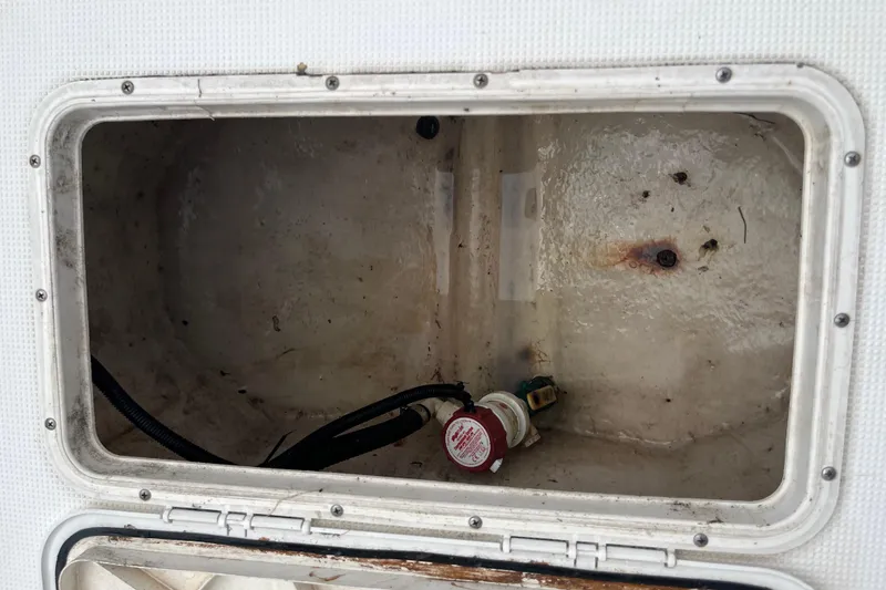 Slide: The Image of Open storage compartment in a 2007 Duskey 256 boat, showing wiring and connectors. - 17
