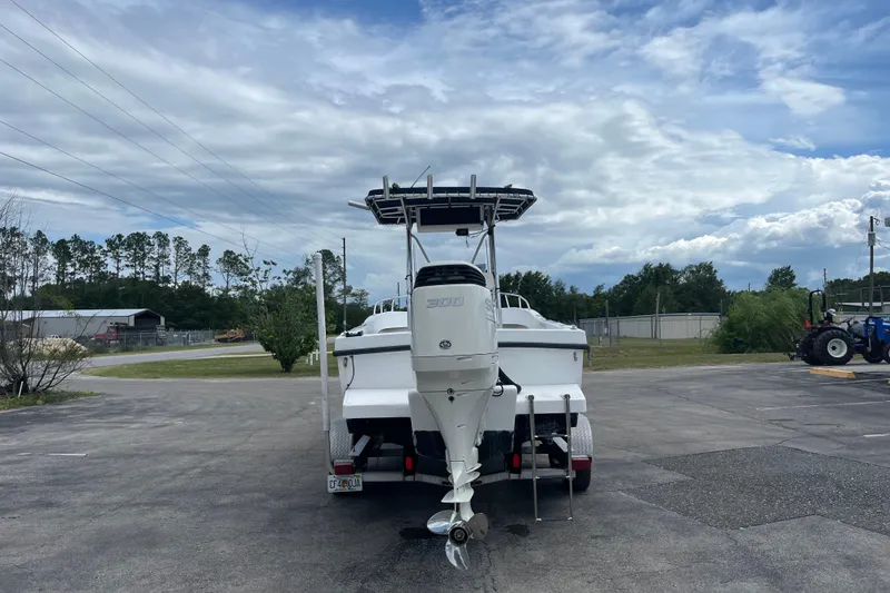 Slide: The Image of Boat on trailer with outboard motor, Duskey 256 model, 2007, parked outdoors under cloudy sky. - 1