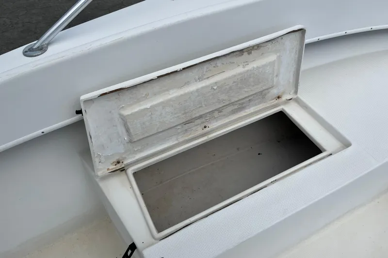 Slide: The Image of Open storage compartment on a 2007 Duskey 256 boat, showing interior space. - 8