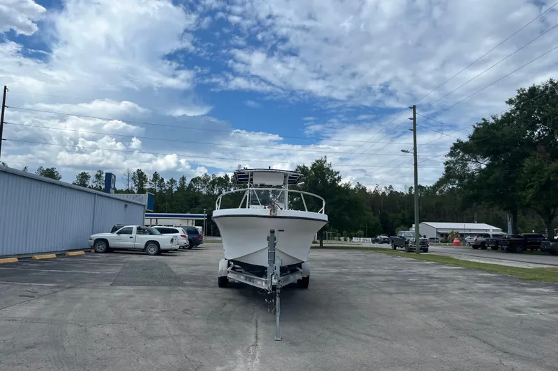 Slide: The Image of ```json { "alt_text": "Duskey 256 boat on trailer in parking lot, cloudy sky, 2007 model." } ``` - 5