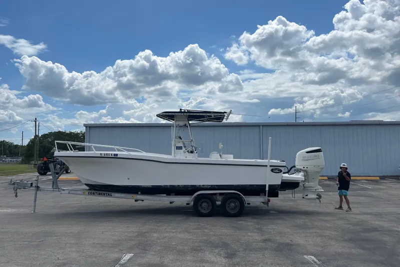 The Image of Duskey 256 boat on trailer, parked outdoors, under a partly cloudy sky. - 0