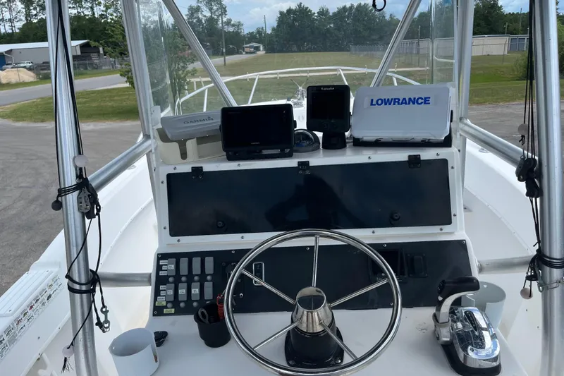 Slide: The Image of Boat dashboard with steering wheel, electronic displays, and navigation equipment, Duskey 256, 2007 model. - 16