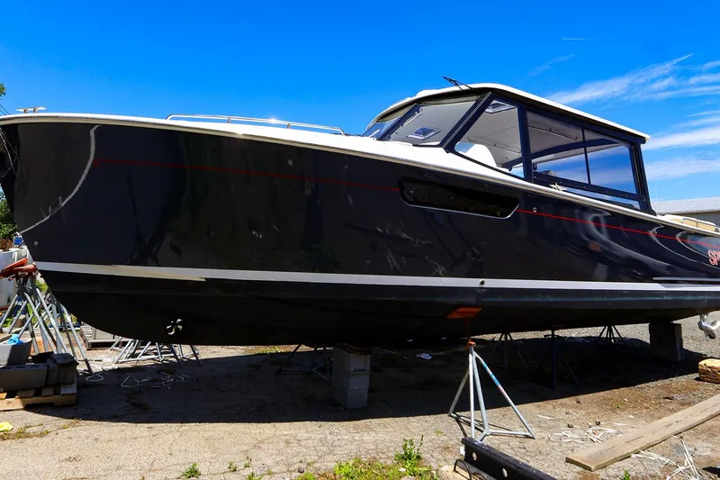 Slide: The Image of 2022 MJM 3z boat on stands under clear blue sky. - 6