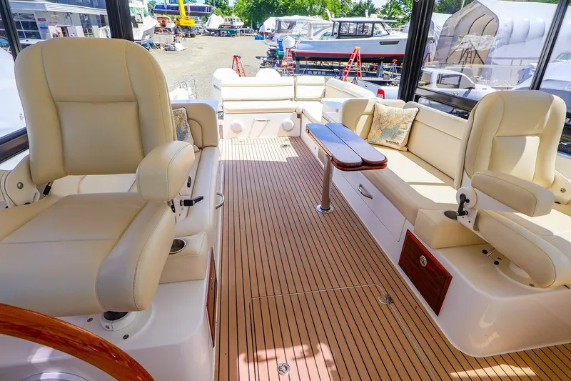 Slide: The Image of Luxurious interior of 2022 MJM 3z boat with beige seating and wooden flooring. - 14