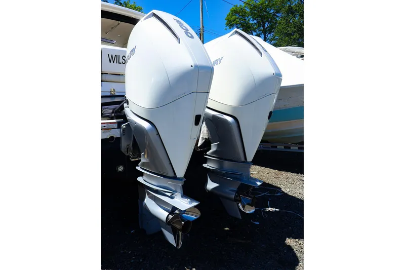 Slide: The Image of Twin outboard motors on a boat, MJM 3z model, 2022, in a sunny outdoor setting. - 7