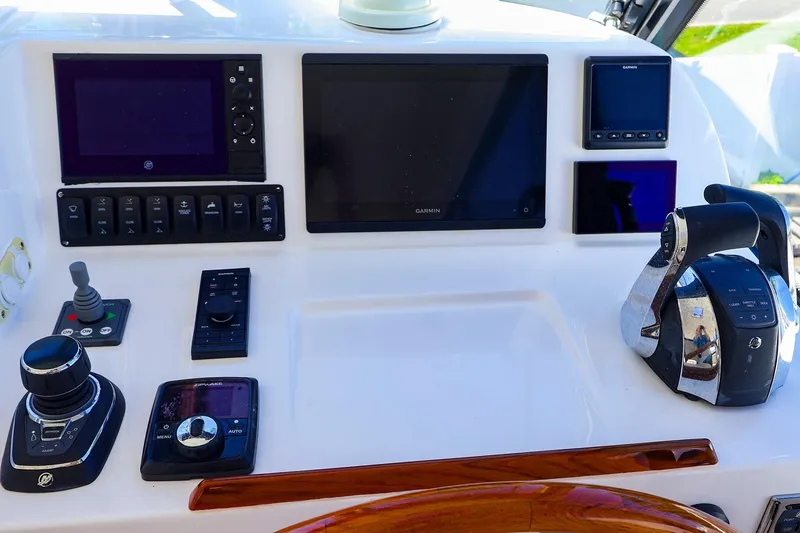 Slide: The Image of Control panel of 2022 MJM 3z boat with navigation screens and throttle controls. - 11