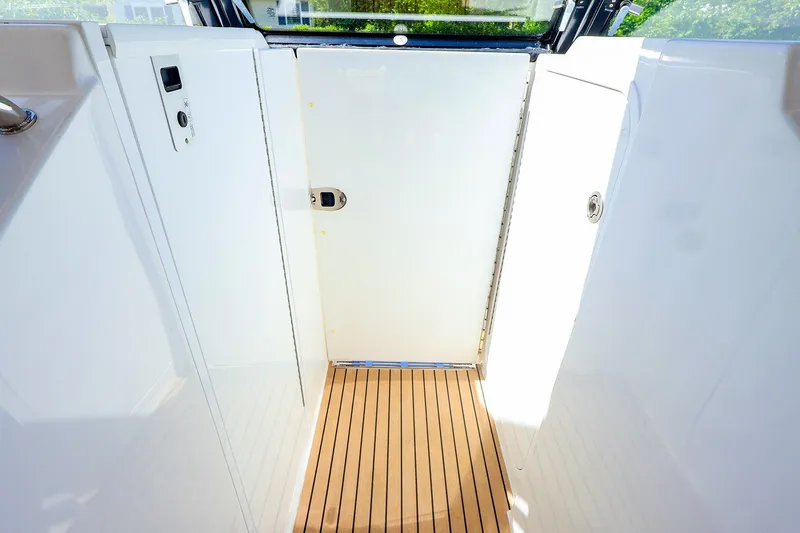 Slide: The Image of Interior view of 2022 MJM 3z boat with sleek white panels and wooden flooring. - 28