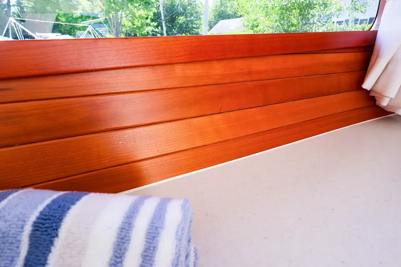 Slide: The Image of Interior of 2022 MJM 3z boat with wooden paneling and striped towel. - 47