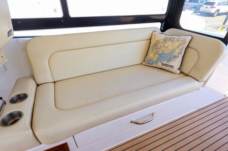 Slide: The Image of Luxurious seating on 2022 MJM 3z boat with map-themed cushion and cup holders. - 20