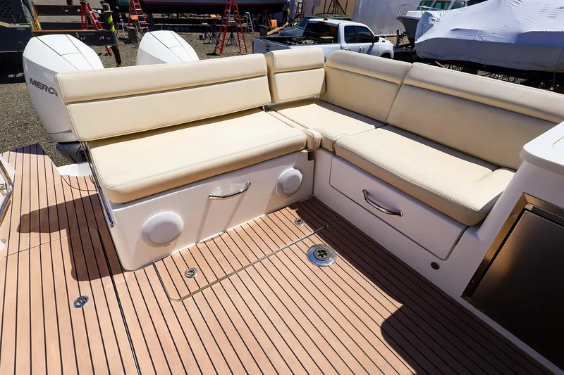 Slide: The Image of Luxurious seating on 2022 MJM 3z boat with beige cushions and wooden deck. - 27
