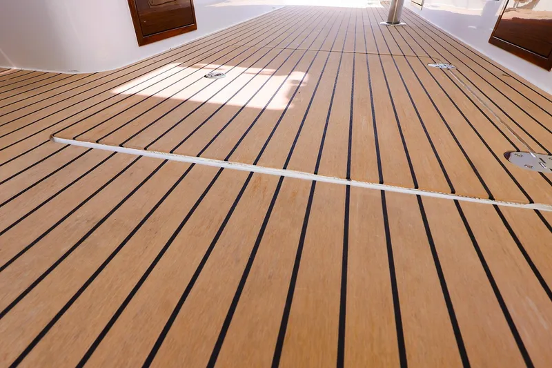 Slide: The Image of Teak deck of 2022 MJM 3z boat, featuring sleek, parallel lines and polished finish. - 35