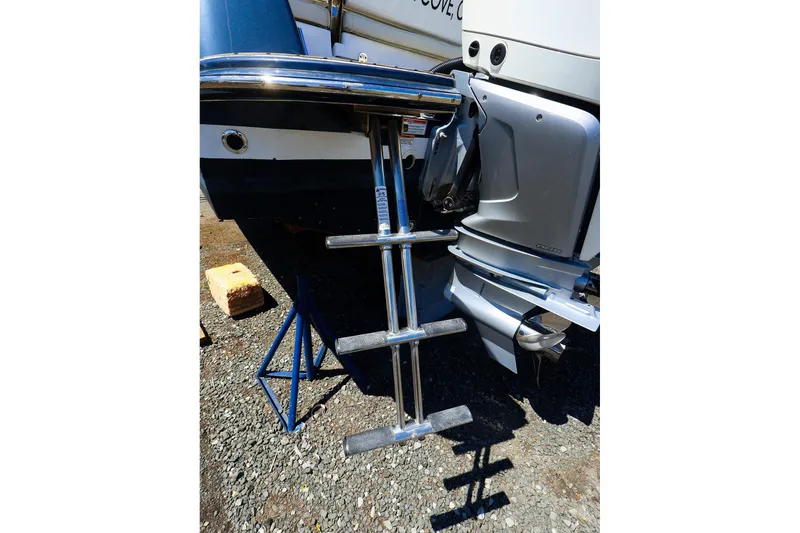Slide: The Image of Boat ladder and motor of 2022 MJM 3z model on a stand outdoors. - 45