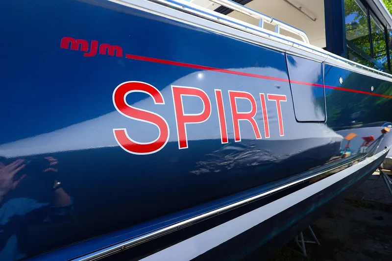 Slide: The Image of Blue MJM 3z boat with "SPIRIT" in red letters, 2022 model. - 8