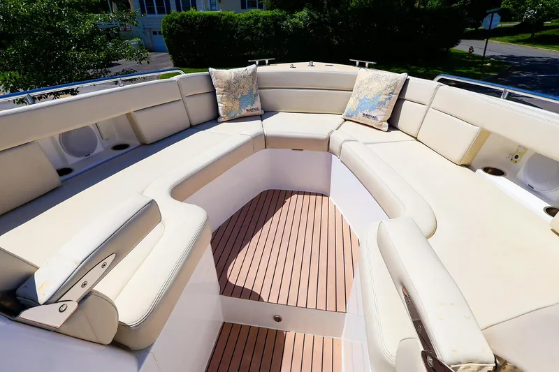 Slide: The Image of Luxurious seating area on 2022 MJM 3z boat with beige cushions and wooden flooring. - 23