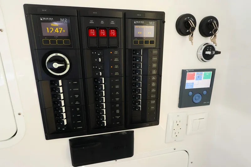 Slide: The Image of Electrical control panel on a 2022 MJM 3z boat, featuring voltage display and switches. - 38