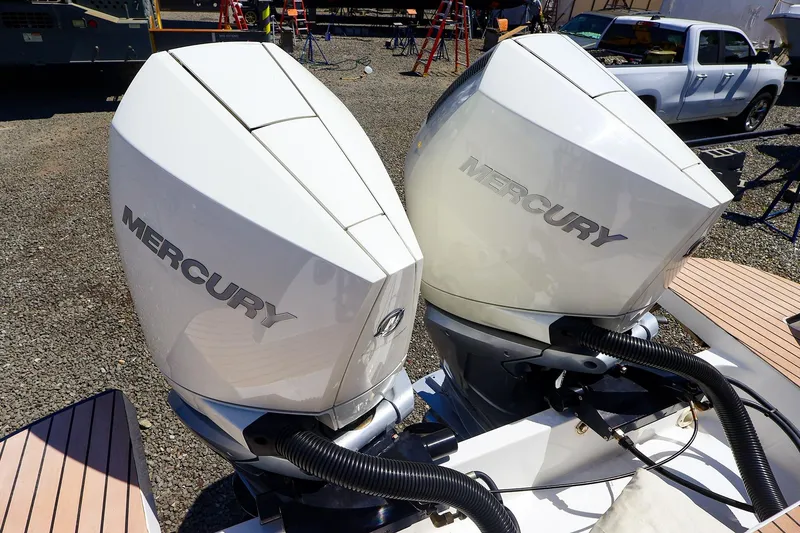 Slide: The Image of Twin Mercury outboard engines on a 2022 MJM 3z boat, parked outdoors. - 48