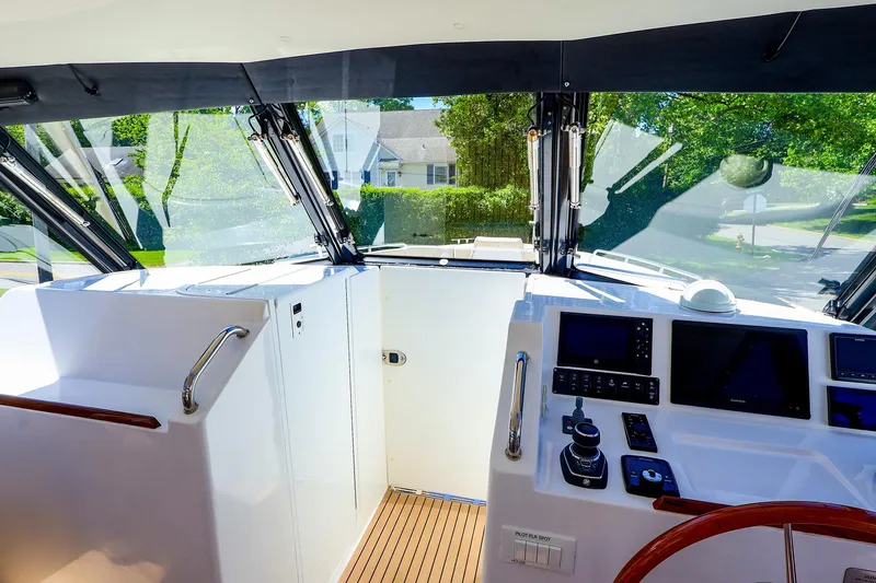 Slide: The Image of Interior view of 2022 MJM 3z yacht cockpit with navigation controls and panoramic windows. - 16
