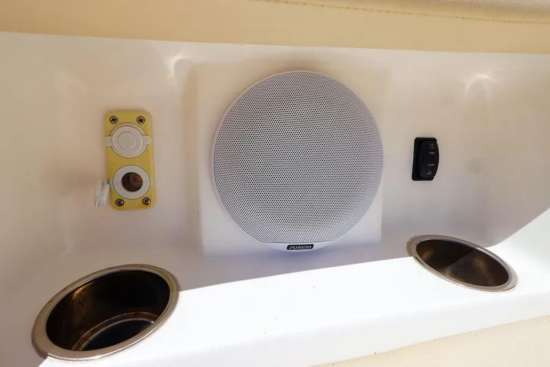 Slide: The Image of Boat interior with Fusion speaker, switch, and cup holders on MJM 3z, 2022 model. - 30