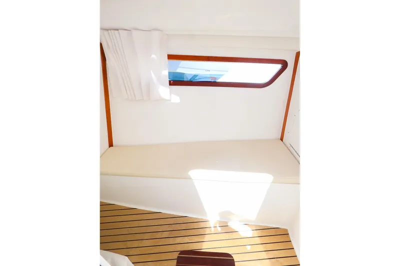 Slide: The Image of Interior of 2022 MJM 3z boat with wooden flooring and window. - 37