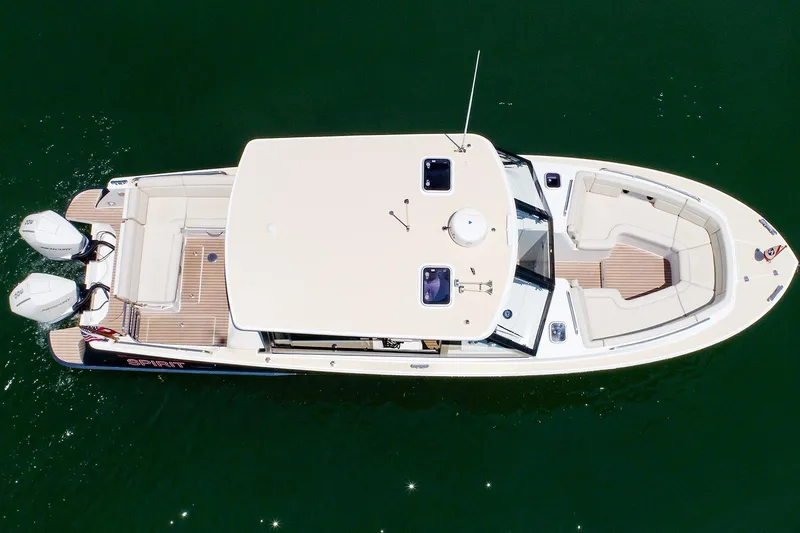 Slide: The Image of Overhead view of 2022 MJM 3z boat with dual engines on calm water. - 2