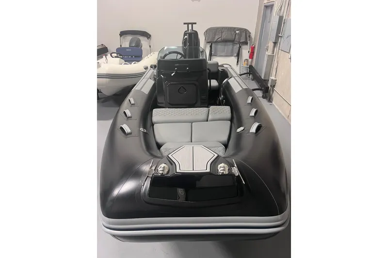Slide: The Image of 2026 Brig Eagle 4 inflatable boat with sleek black design and modern seating. - 2
