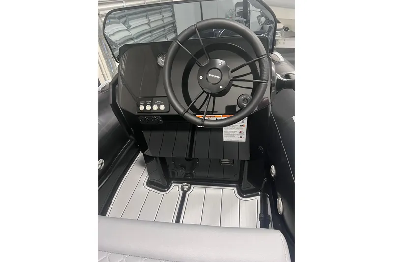 Slide: The Image of 2026 Brig Eagle 4 boat cockpit with steering wheel and control panel. - 4