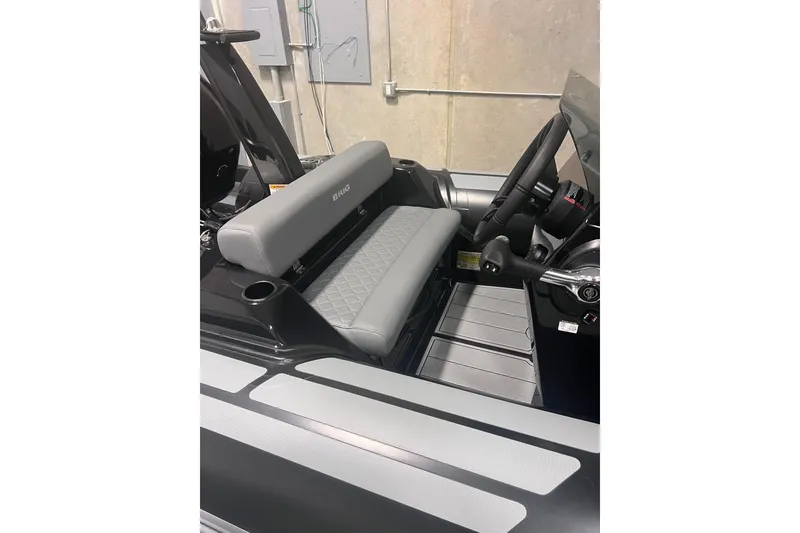Slide: The Image of Interior of 2026 Brig Eagle 4 boat with gray seating and steering console. - 3