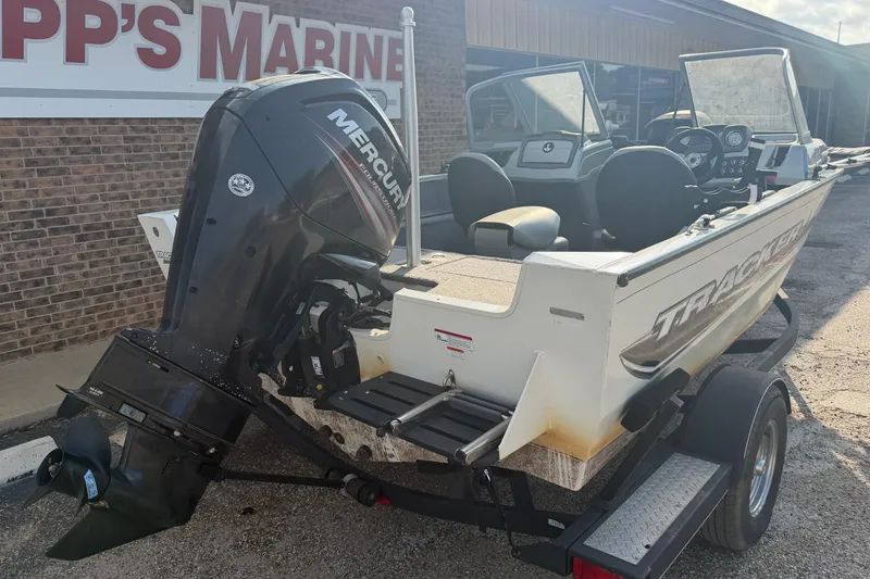 Slide: The Image of 2018 Tracker Pro Guide V-165 WT boat with Mercury engine at a marine dealership. - 7
