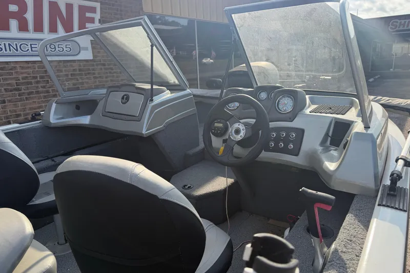 Slide: The Image of 2018 Tracker Pro Guide V-165 WT boat interior with steering wheel and dashboard controls. - 3