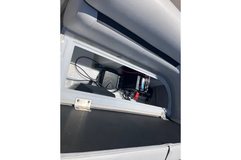 Slide: The Image of Storage compartment of 2023 Godfrey Sweetwater 2286 BF boat, showing electrical components and wiring. - 5