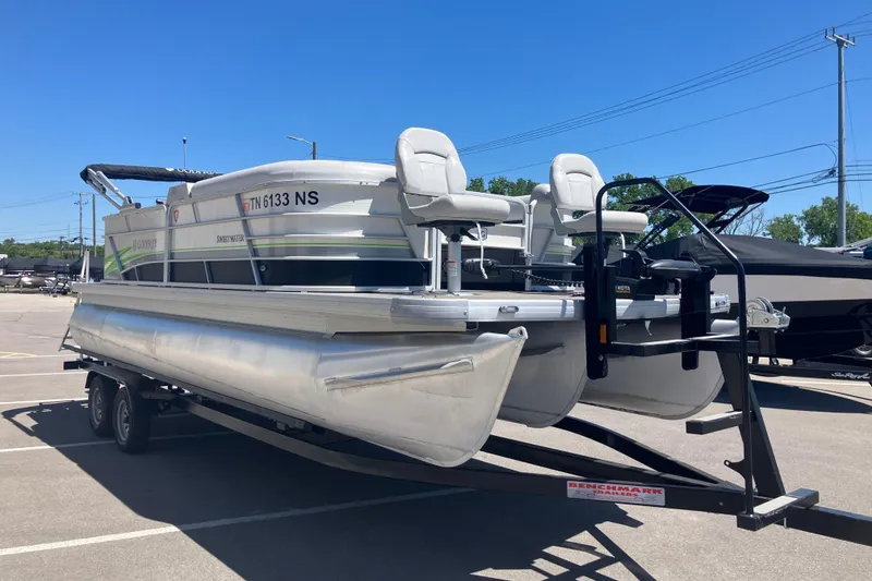 The Image of 2023 Godfrey Sweetwater 2286 BF pontoon boat on trailer in parking lot. - 0