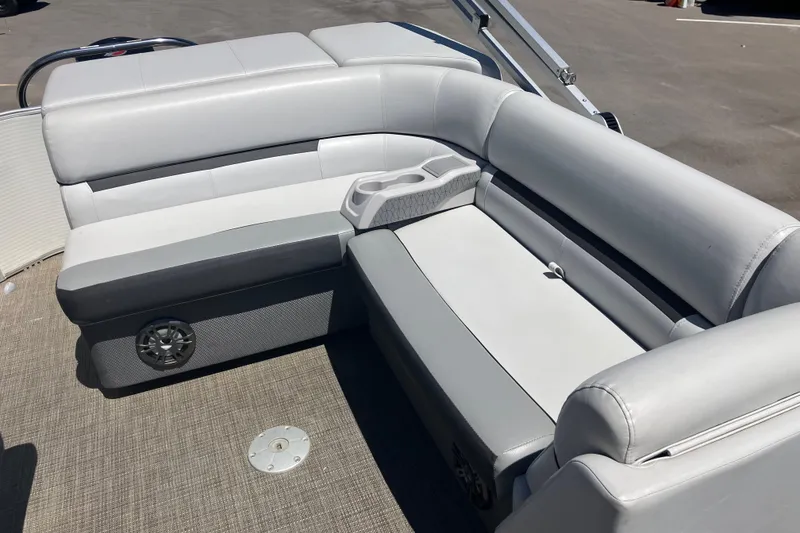 Slide: The Image of 2023 Godfrey Sweetwater 2286 BF boat interior with gray seating and cup holders. - 10