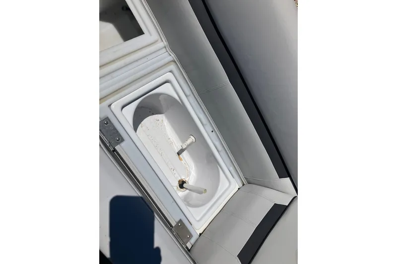 Slide: The Image of Livewell compartment on 2023 Godfrey Sweetwater 2286 BF boat, featuring white interior. - 4