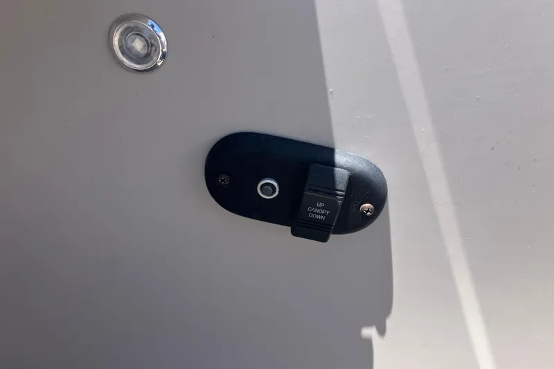 Slide: The Image of Switch panel on 2023 Godfrey Sweetwater 2286 BF boat for canopy control. - 7