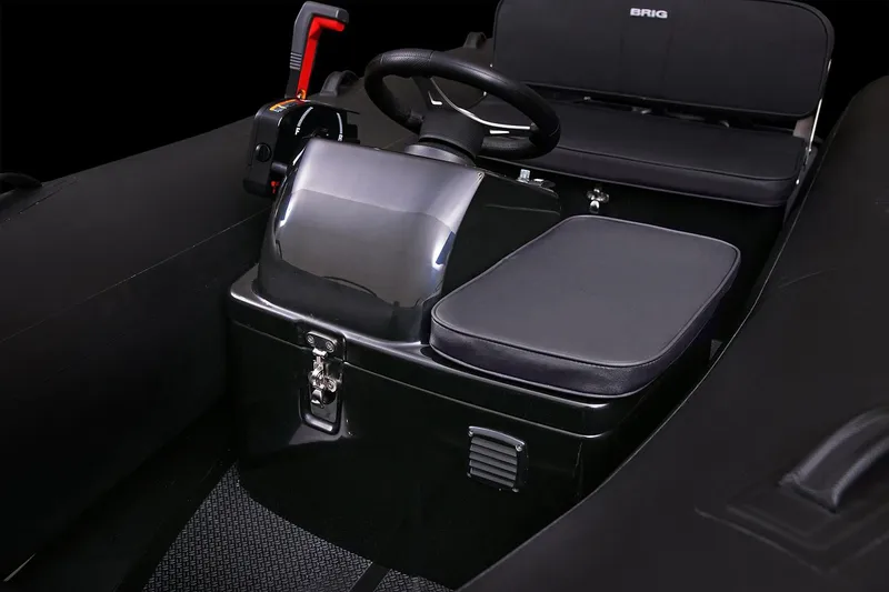 Slide: The Image of Manufacturer Provided Image: Interior of 2026 Brig Falcon Tender 360 with black seat and steering. - 4