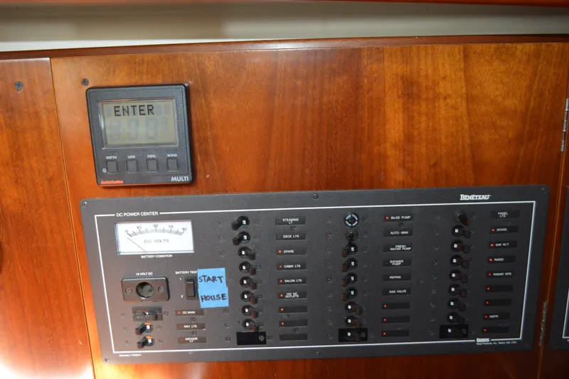 Slide: The Image of Control panel of a 1999 Beneteau 411 sailboat with various switches and gauges. - 33