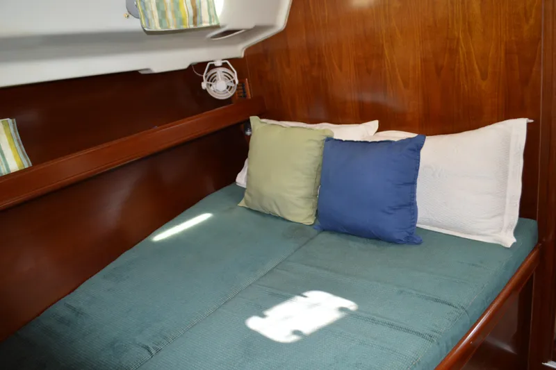 Slide: The Image of Cozy cabin interior of 1999 Beneteau 411 yacht with colorful pillows and wooden finish. - 41