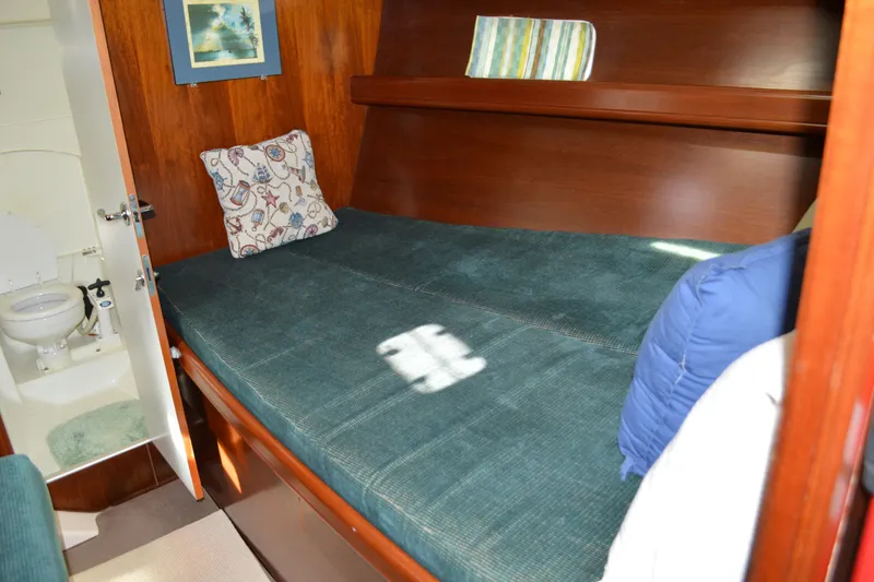 Slide: The Image of Cozy cabin interior of 1999 Beneteau 411 yacht with bed and adjacent bathroom. - 40