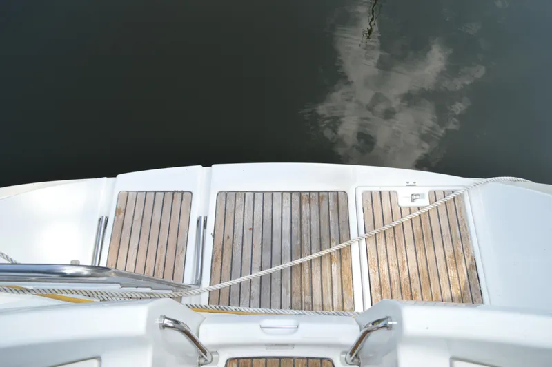Slide: The Image of Stern view of 1999 Beneteau 411 yacht with wooden deck and mooring rope. - 17
