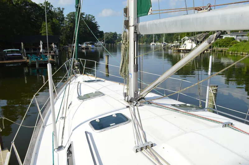 Slide: The Image of Sailboat Beneteau 411 (1999) docked in a serene marina setting. - 6