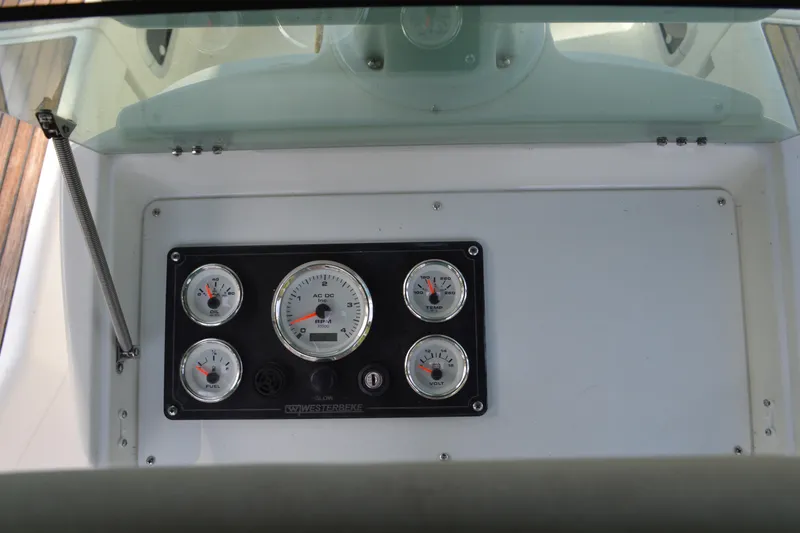 Slide: The Image of Instrument panel of a 1999 Beneteau 411 sailboat, featuring gauges for oil, temperature, fuel, and voltage. - 16