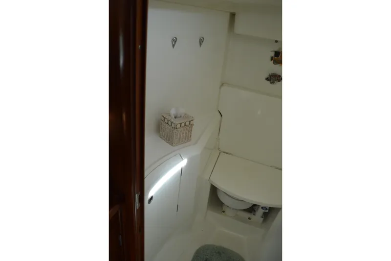 Slide: The Image of Interior of 1999 Beneteau 411 yacht bathroom with compact design and white fixtures. - 46